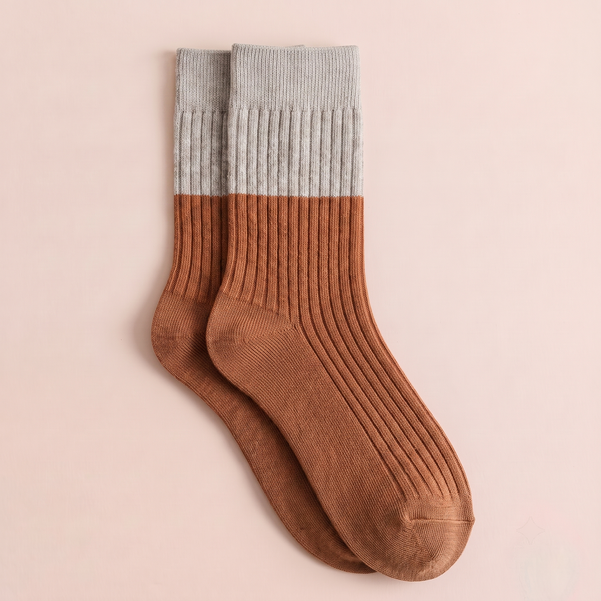 Women's merino wool dress socks in rust brown with a grey cuff, featuring a color-block ribbed knit. Shown as a single flat-lay on a pink backdrop.