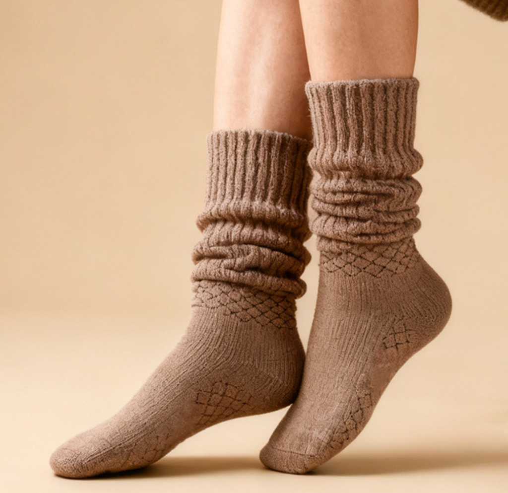Women's slouch socks in tan knit, featuring a scrunched slouchy leg. Worn on the legs in a cozy style.