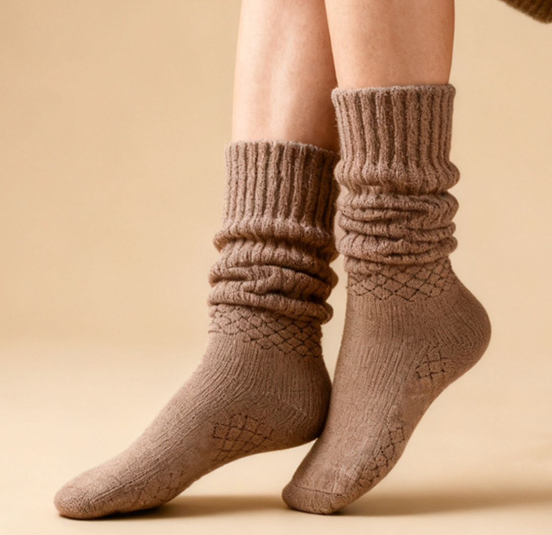 Women's slouch socks in tan knit, featuring a scrunched slouchy leg. Worn on the legs in a cozy style.