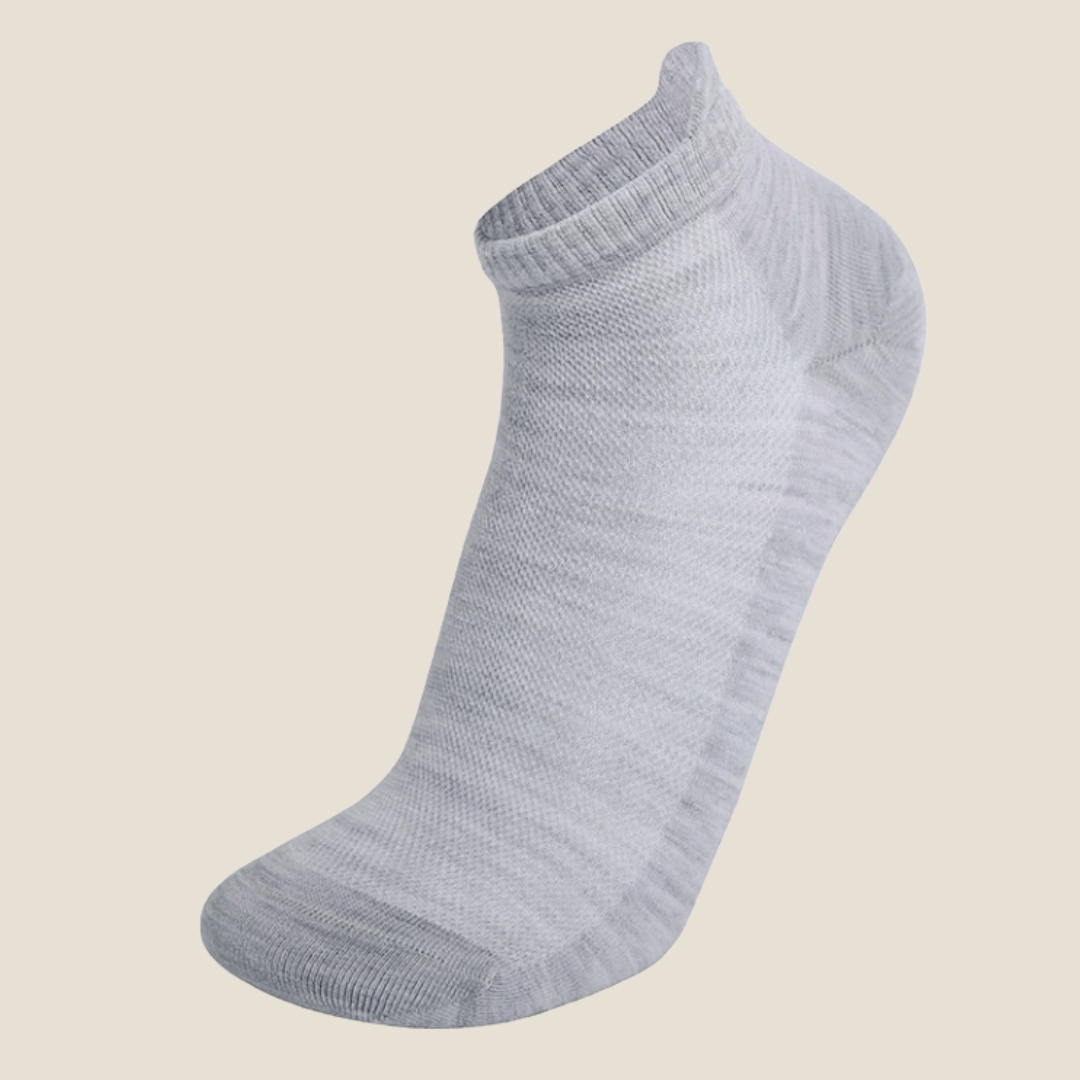 Wool ankle socks in light blue-grey, featuring a marled wool knit. Displayed flat on a neutral surface.