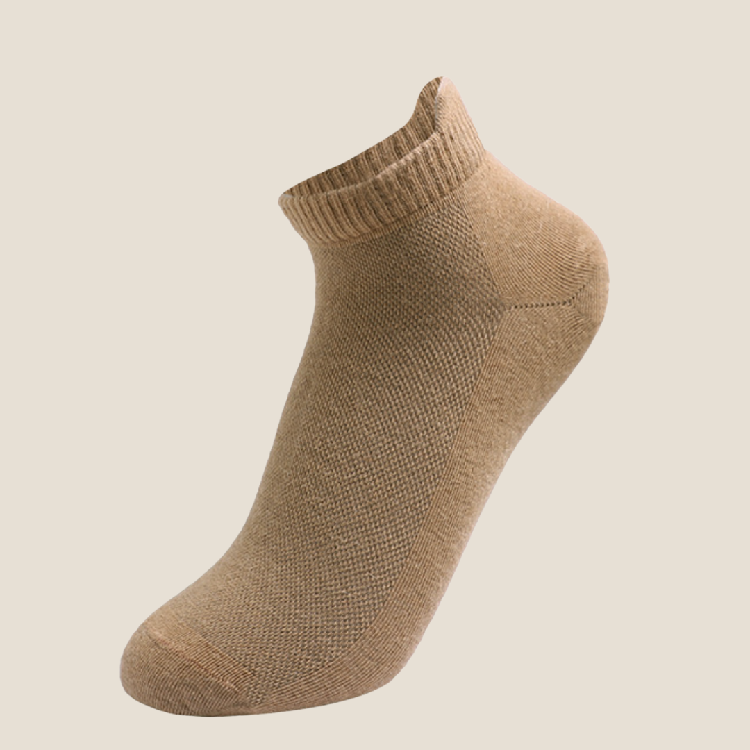 Wool ankle socks in camel, featuring a soft ribbed cuff. Shown as a single flat-lay on a light backdrop.