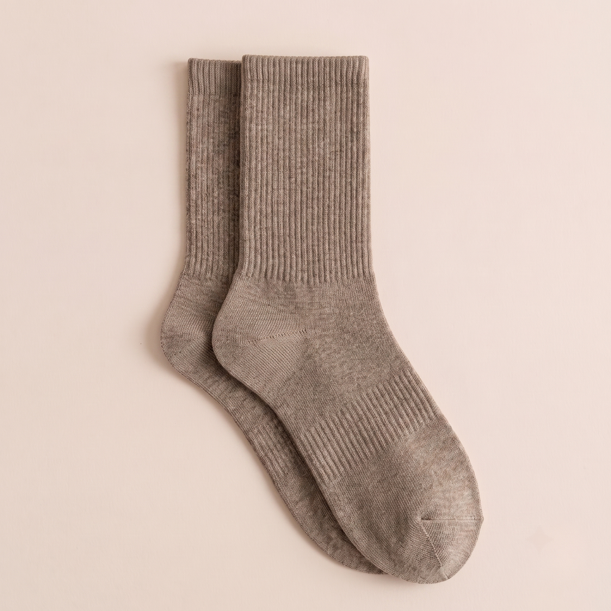 Women's wool boot socks in taupe marled knit, featuring a chunky ribbed texture. Shown as a flat-lay pair on a warm neutral backdrop.