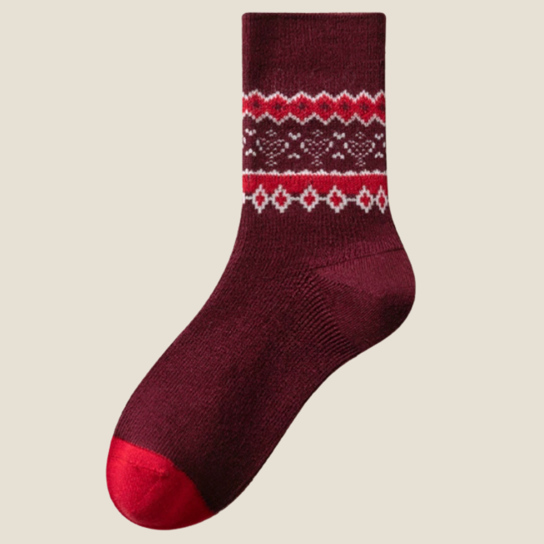 Wool Christmas socks in burgundy Fair Isle with a contrasting red toe, single sock laid flat.