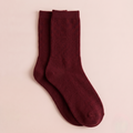 Women's wool dress socks in burgundy ribbed wool, featuring a soft crew length. Shown as an upright flat-lay pair.