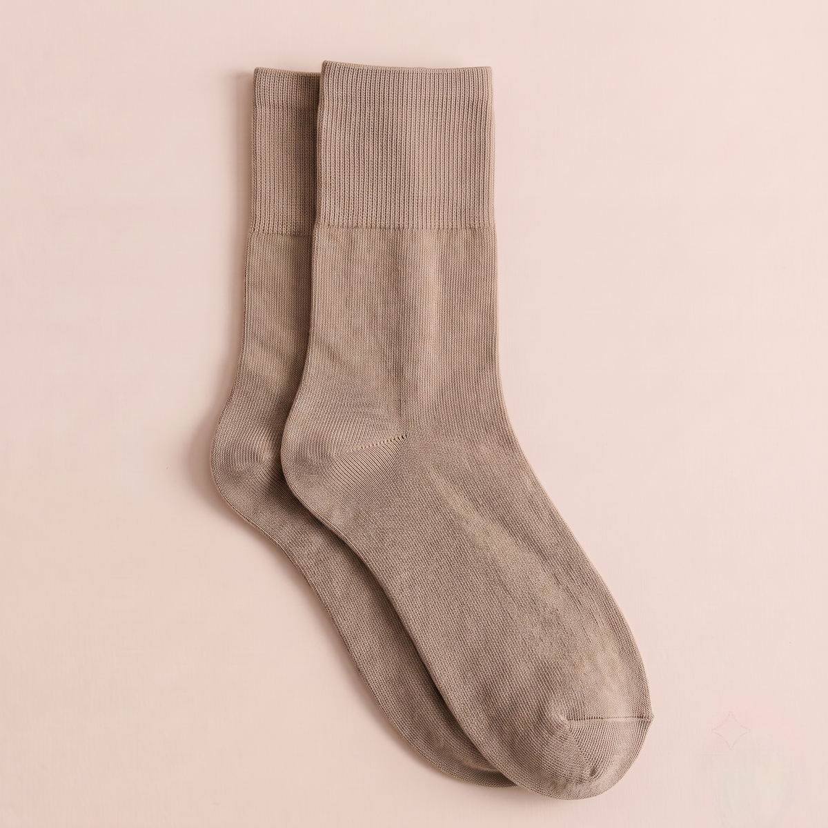 Women's wool dress socks in taupe ribbed wool, featuring a fine texture. Displayed flat as a pair on a pink surface.