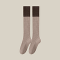 Wool knee socks in beige with a contrasting brown cuff, featuring a color-block ribbed knit. Shown as an upright flat-lay pair.
