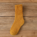 Wool thick socks in golden mustard wool, featuring a warm ribbed weave. Displayed flat to show the thick pile.