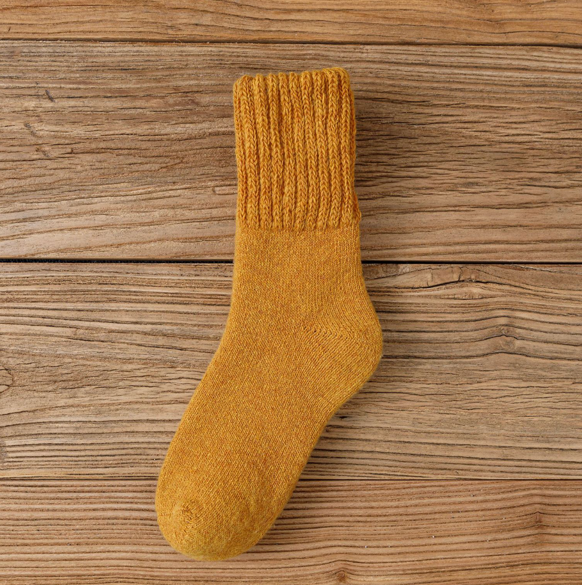 Wool thick socks in golden mustard wool, featuring a warm ribbed weave. Displayed flat to show the thick pile.