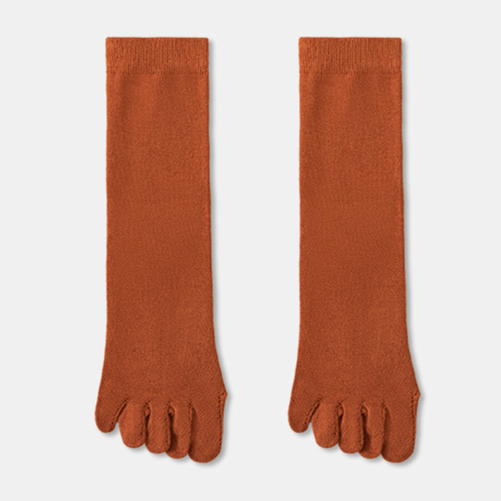 Wool toe socks in rust orange ribbed knit, featuring individual toe pockets. Shown as a flat-lay pair on a neutral backdrop.
