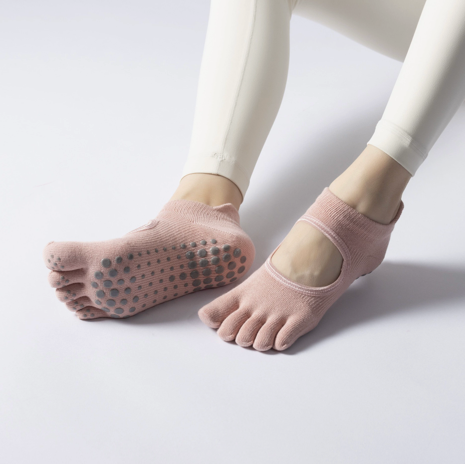 Yoga toe socks in beige knit, featuring a backless open-toe cut and non-slip grip dots. Worn to show the pilates fit.